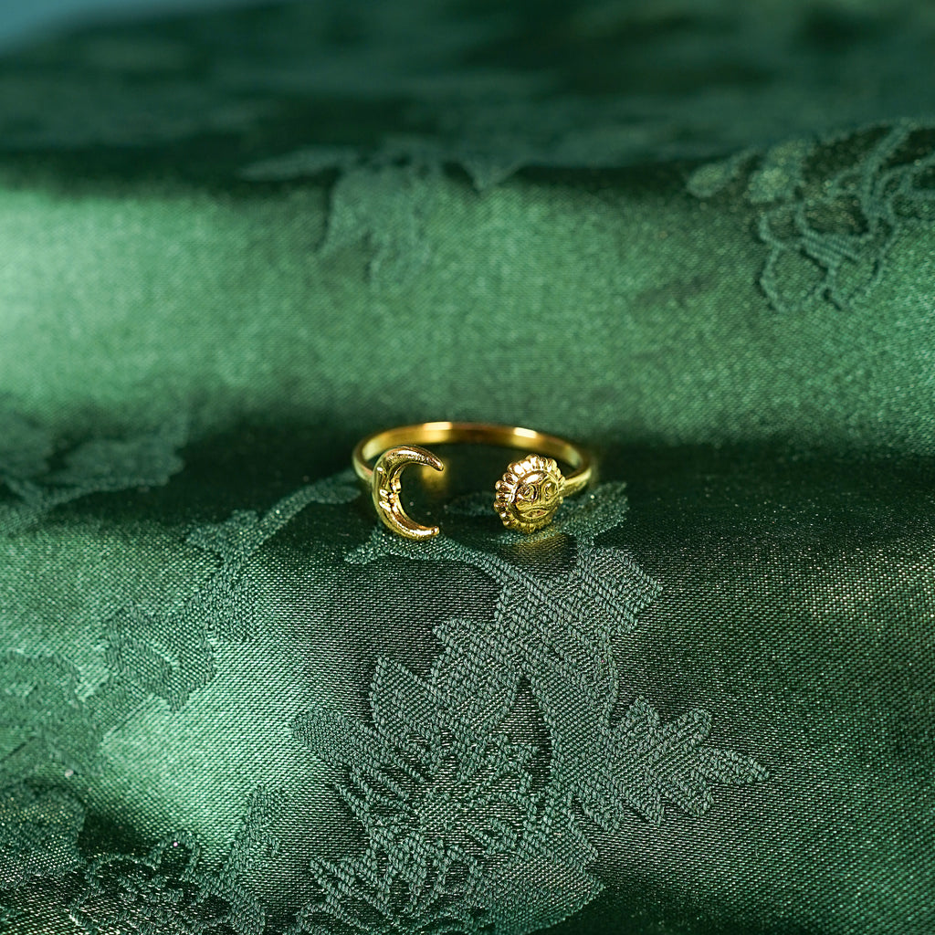 Gold adjustable ring with sun and moon design on silk