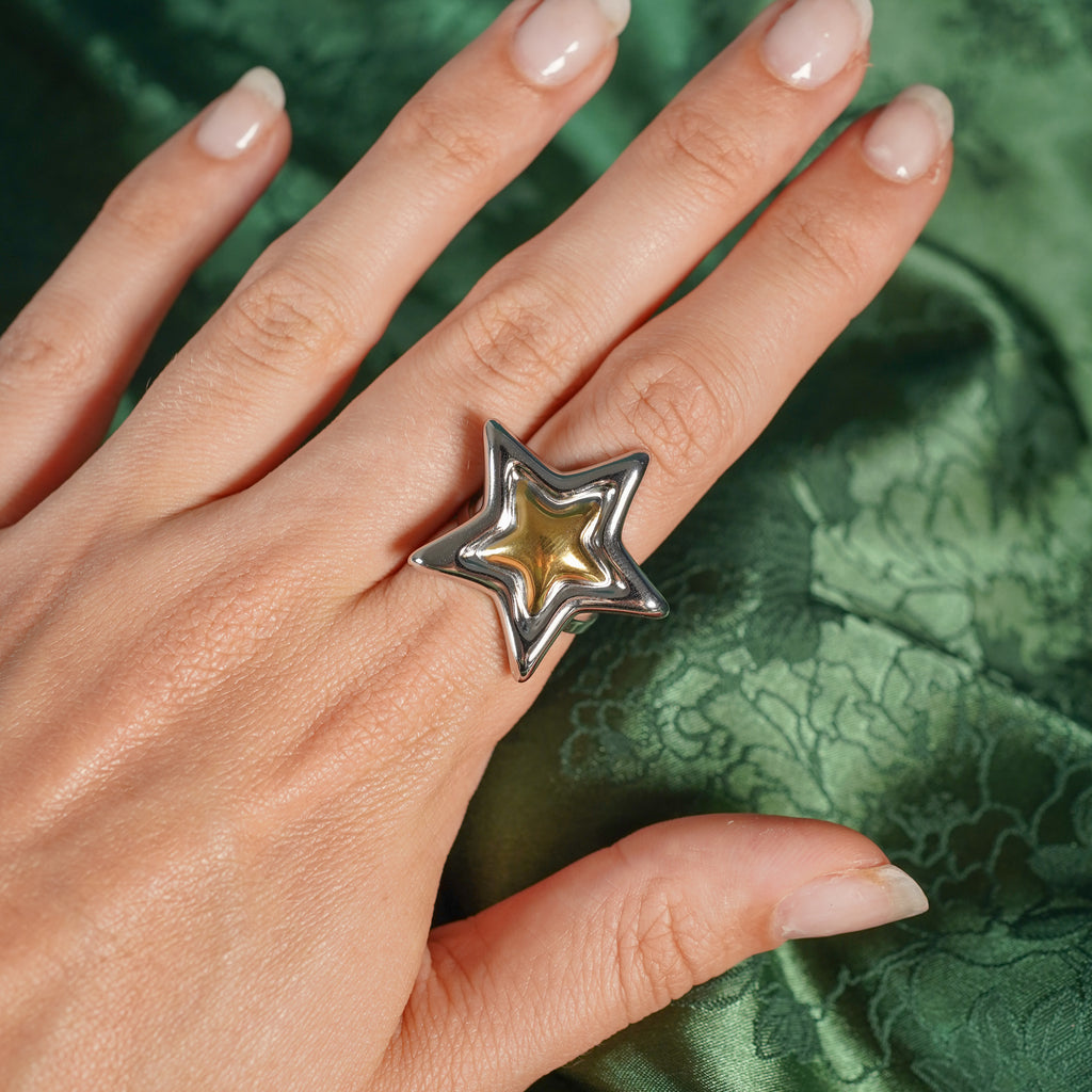 Chunky adjustable star ring on hand