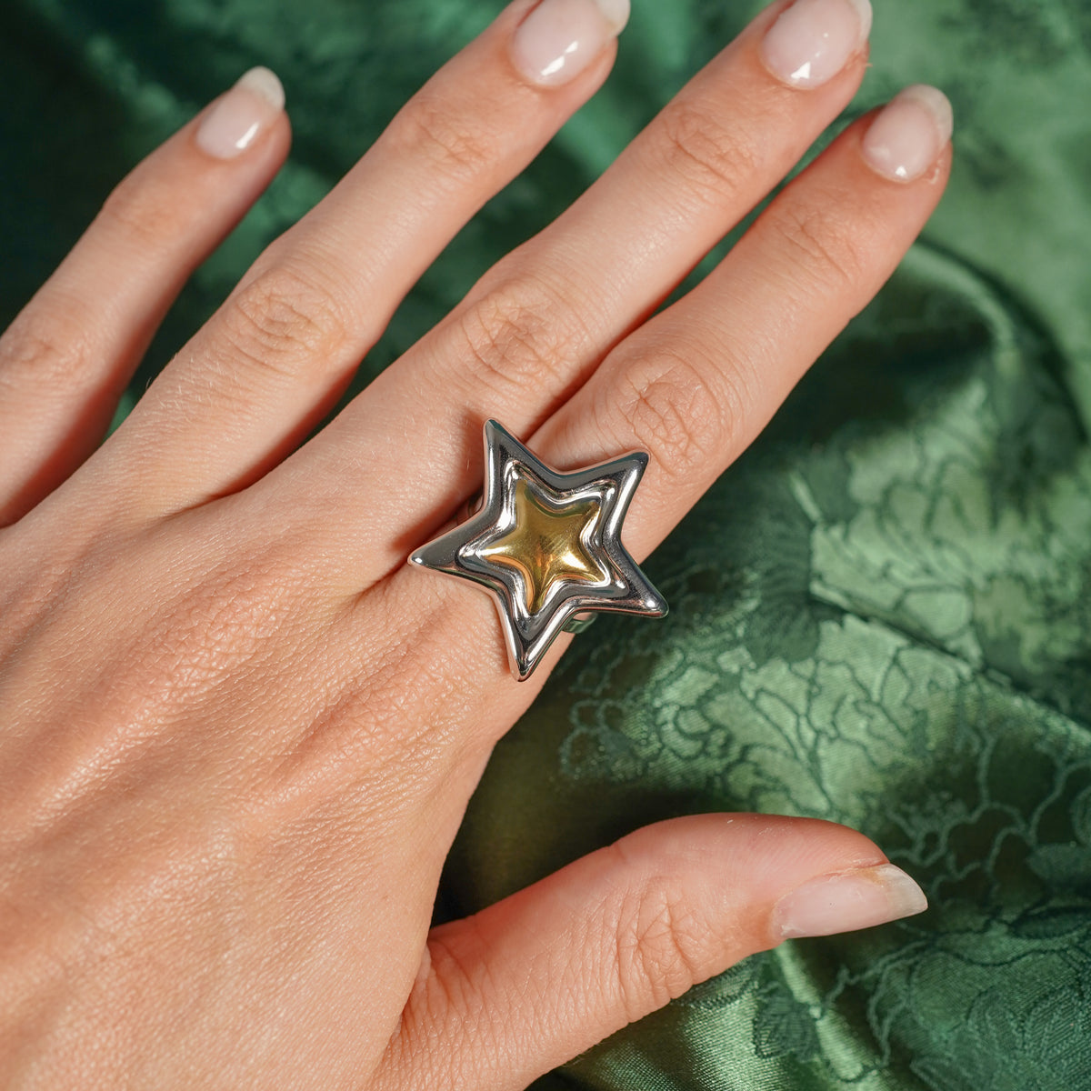 Chunky adjustable star ring on hand