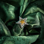 Chunky adjustable star ring on silk close up