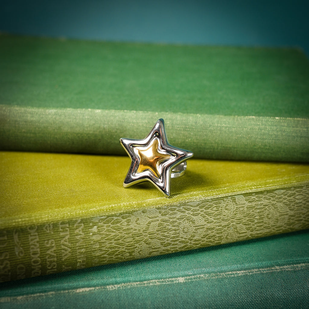 Chunky adjustable star ring on book
